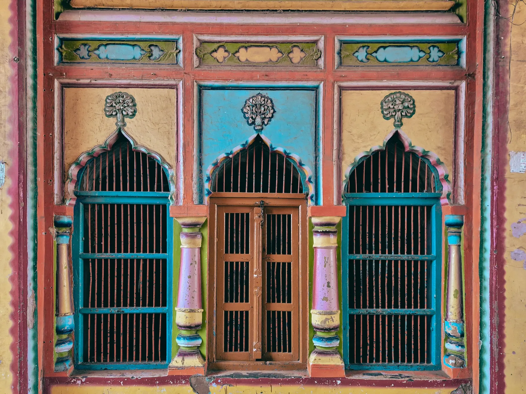 Colorful traditional windows with intricate designs in Ayodhya, Uttar Pradesh, India.