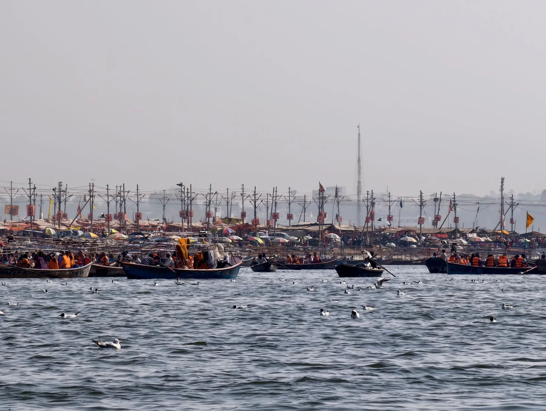 A vibrant scene of boats on the Ganges amidst Kumbh Mela festivities in Prayagraj, India.
