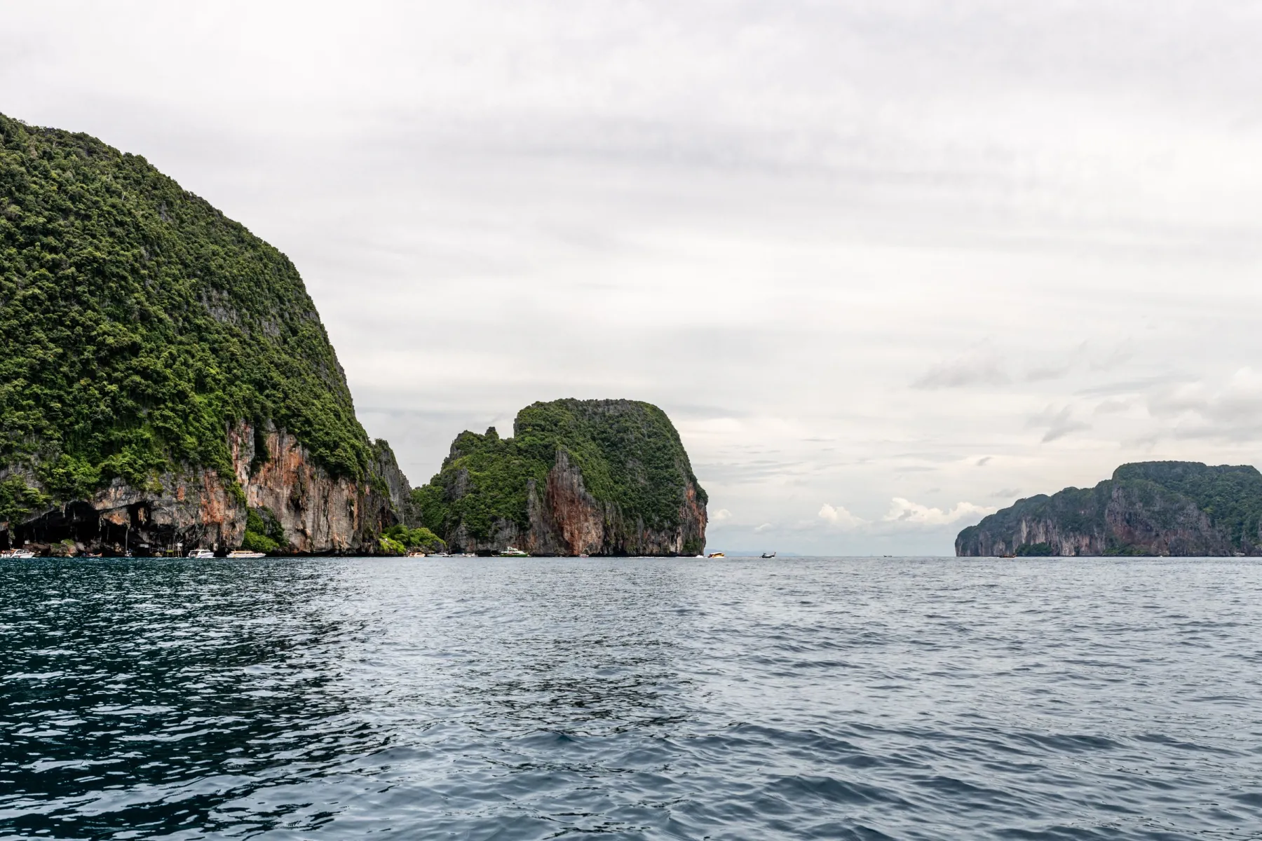 Explore the breathtaking limestone cliffs and serene sea in Phuket, Thailand.